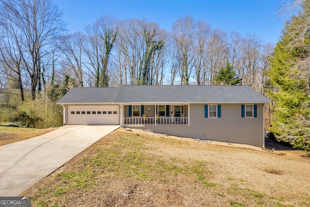 ranch-style house featuring a garage, covered porch, and concrete driveway