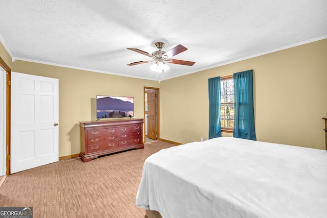 bedroom with a textured ceiling, ornamental molding, and baseboards