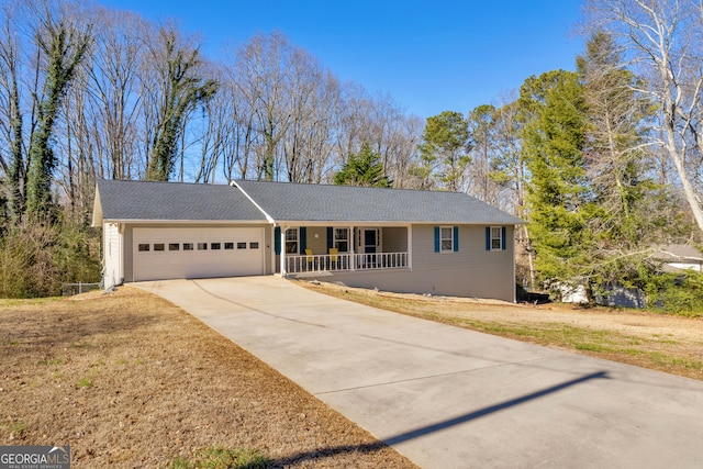 ranch-style home with covered porch, concrete driveway, a front lawn, and an attached garage