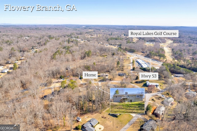 birds eye view of property featuring a wooded view