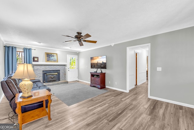 living area with ornamental molding and wood finished floors