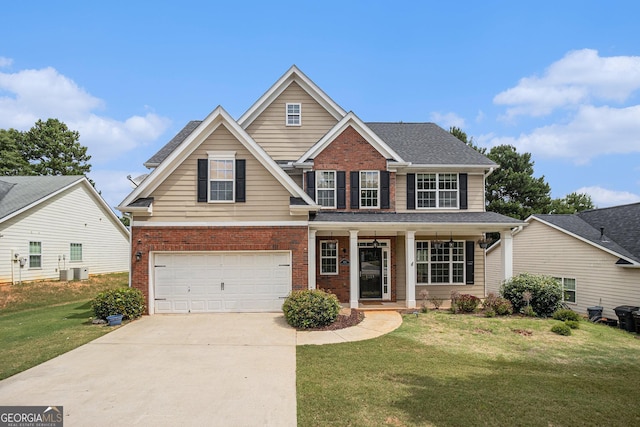 traditional home with a garage, brick siding, driveway, roof with shingles, and a front yard