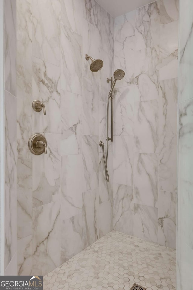 bathroom with a marble finish shower