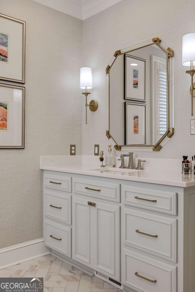 bathroom featuring ornamental molding, marble finish floor, vanity, and baseboards