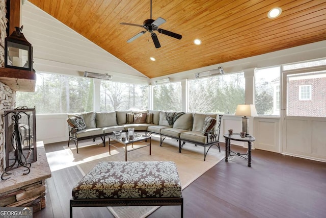 sunroom featuring vaulted ceiling, wooden ceiling, a wealth of natural light, and a ceiling fan