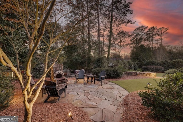 patio terrace at dusk with fence and a lawn