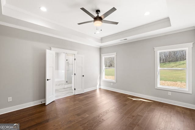 unfurnished bedroom with a raised ceiling, baseboards, and dark wood-style flooring