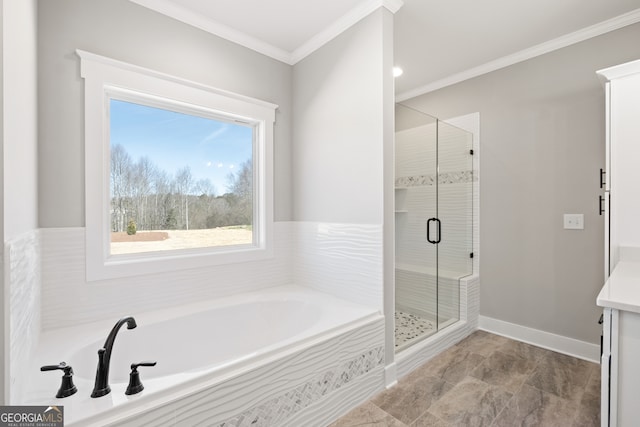 bathroom featuring a stall shower, baseboards, a garden tub, and crown molding