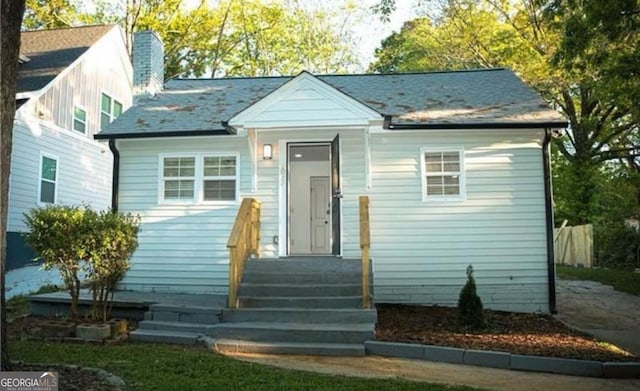 bungalow-style house with a chimney