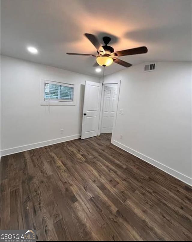 spare room featuring dark wood-style flooring, recessed lighting, visible vents, a ceiling fan, and baseboards