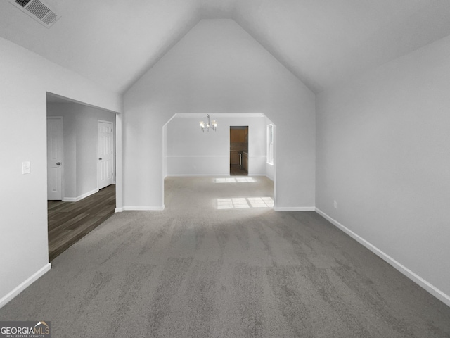 interior space featuring high vaulted ceiling, baseboards, visible vents, and a chandelier