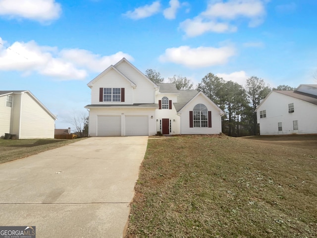 traditional-style home with concrete driveway, an attached garage, and a front yard