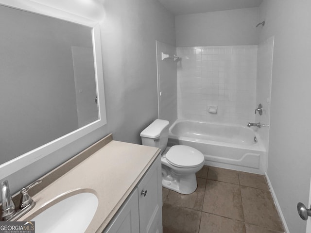 full bathroom featuring tile patterned flooring, toilet, vanity, baseboards, and washtub / shower combination