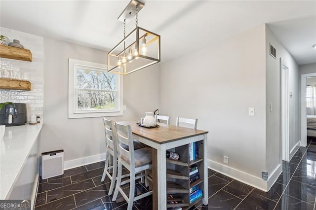 dining room with visible vents and baseboards