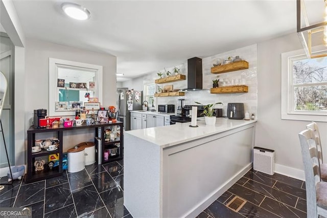 kitchen with extractor fan, stainless steel appliances, white cabinetry, light countertops, and open shelves