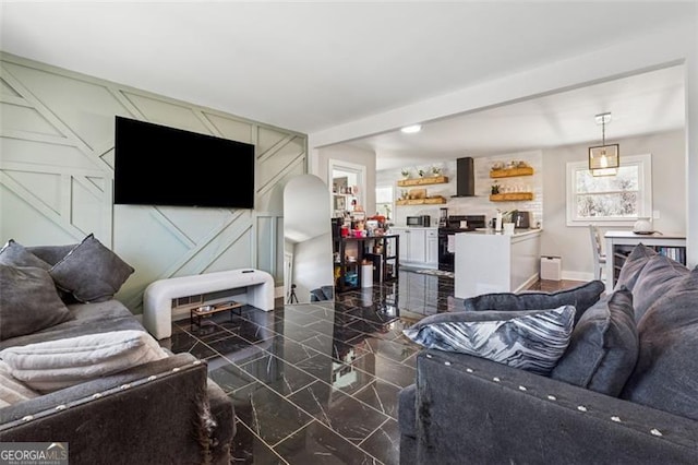 living area with marble finish floor and baseboards