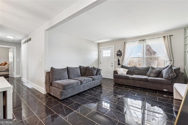 living area featuring marble finish floor, visible vents, and baseboards