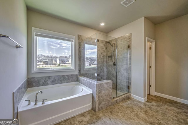 bathroom featuring baseboards, a garden tub, visible vents, and a shower stall