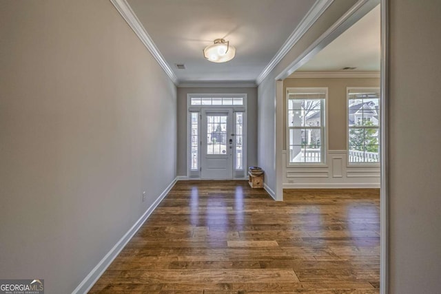 foyer with baseboards, crown molding, visible vents, and dark wood-style flooring