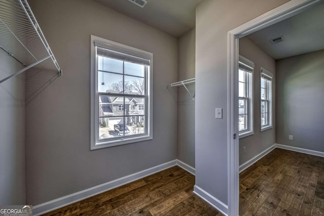 washroom featuring dark wood-style floors, visible vents, and baseboards