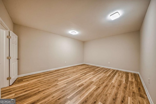 spare room with light wood-style flooring and baseboards