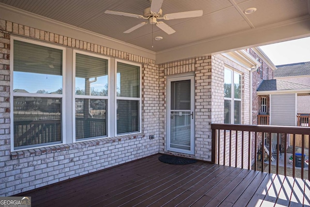 wooden deck with a ceiling fan