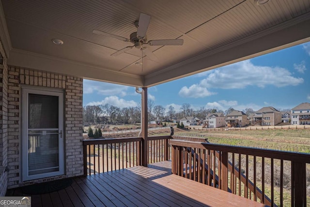 wooden terrace with ceiling fan and a residential view