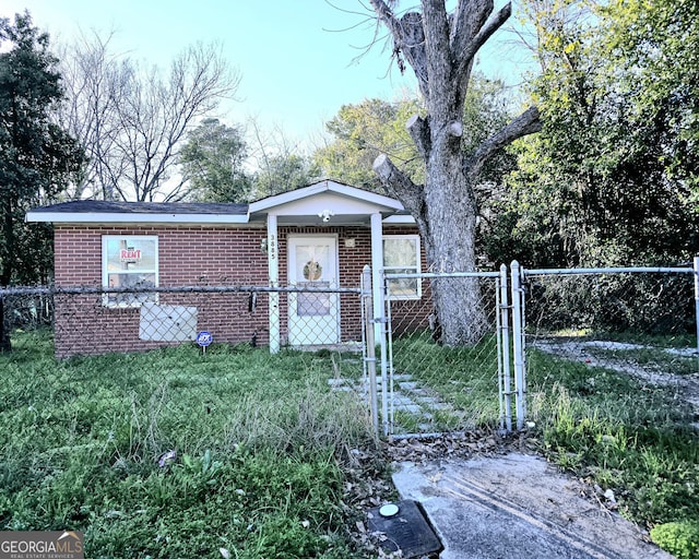 bungalow featuring a fenced front yard, a gate, and brick siding