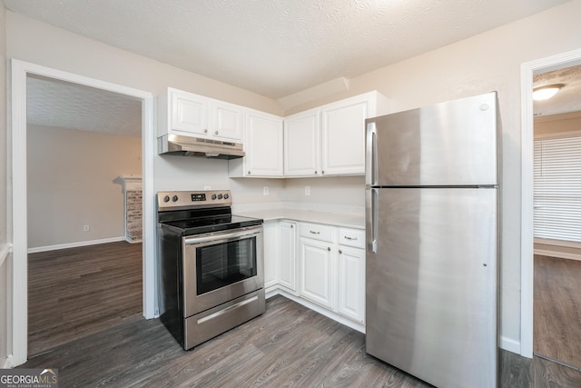 kitchen with white cabinets, dark wood-style flooring, stainless steel appliances, light countertops, and under cabinet range hood