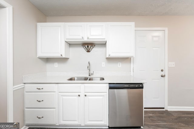 kitchen with light countertops, stainless steel dishwasher, a sink, and white cabinets