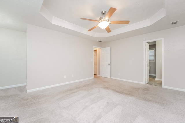 unfurnished room with baseboards, ornamental molding, a raised ceiling, and a textured ceiling