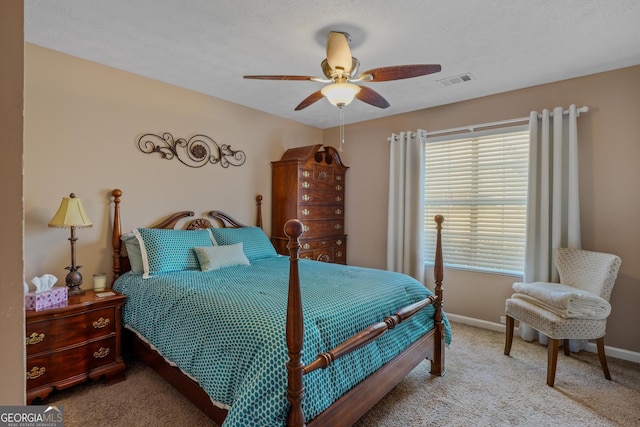 bedroom with a ceiling fan, light colored carpet, visible vents, and baseboards