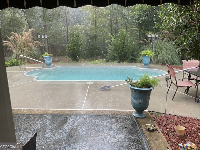 outdoor pool featuring a patio area