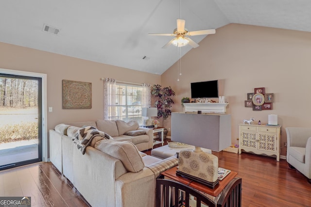 living room with ceiling fan, high vaulted ceiling, dark wood-style flooring, and visible vents