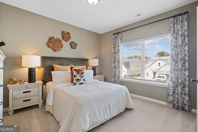 bedroom featuring light carpet, baseboards, and visible vents