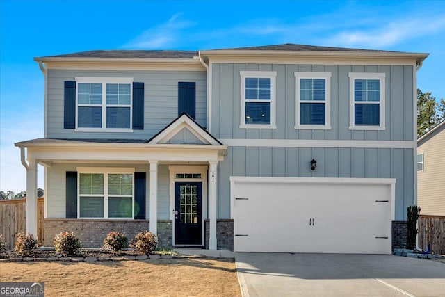 view of front of home with a garage, fence, board and batten siding, and concrete driveway