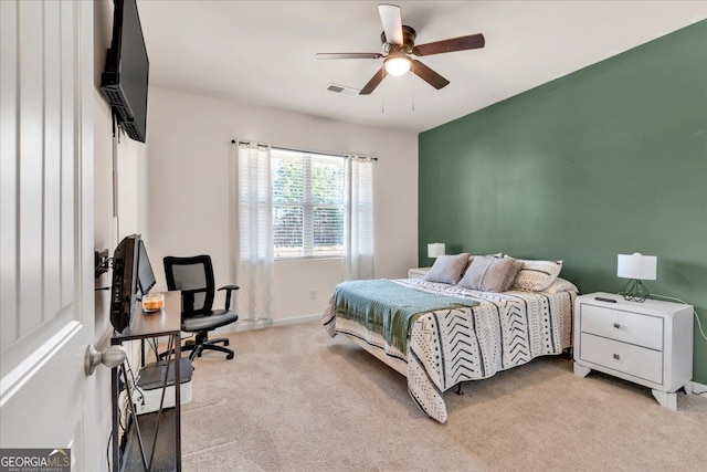 carpeted bedroom with baseboards, visible vents, and a ceiling fan