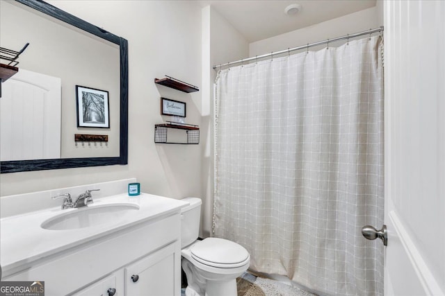 bathroom with vanity, toilet, and a shower with curtain