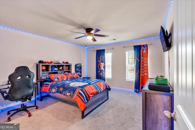 bedroom with carpet, visible vents, and a ceiling fan