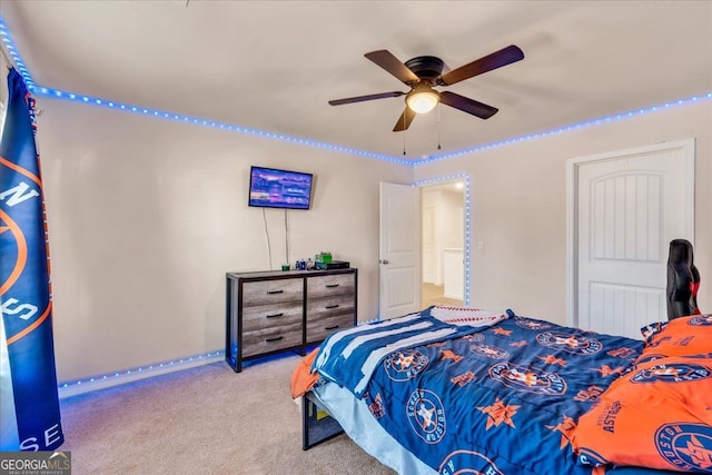 carpeted bedroom with a ceiling fan and baseboards