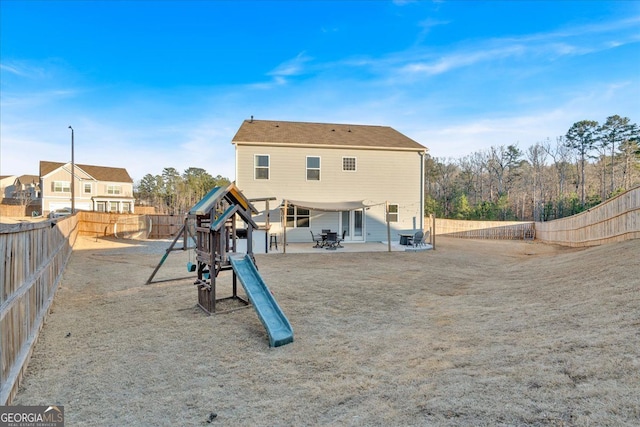 back of house with a patio, a playground, and a fenced backyard