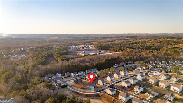 birds eye view of property featuring a forest view and a residential view