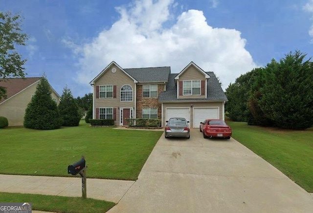 view of front of house with concrete driveway and a front yard