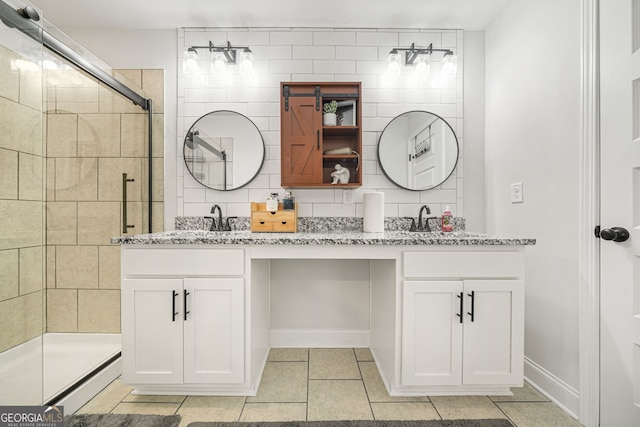 full bathroom featuring double vanity, a shower stall, and a sink