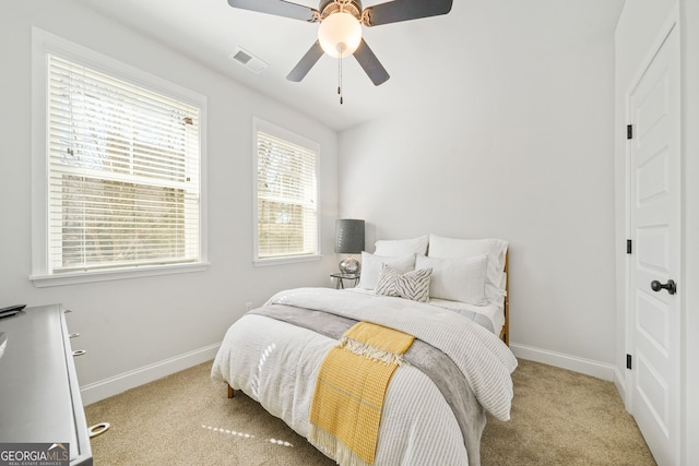 bedroom featuring light carpet, visible vents, and baseboards