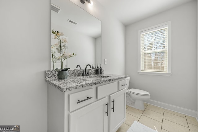 bathroom with visible vents, baseboards, toilet, tile patterned flooring, and vanity