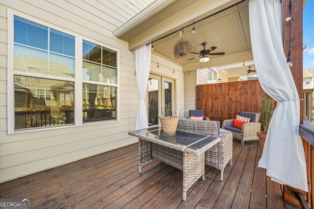 wooden terrace with fence and a ceiling fan