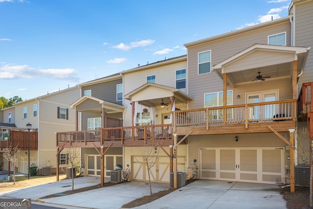 view of front of property with an attached garage, driveway, ceiling fan, and cooling unit