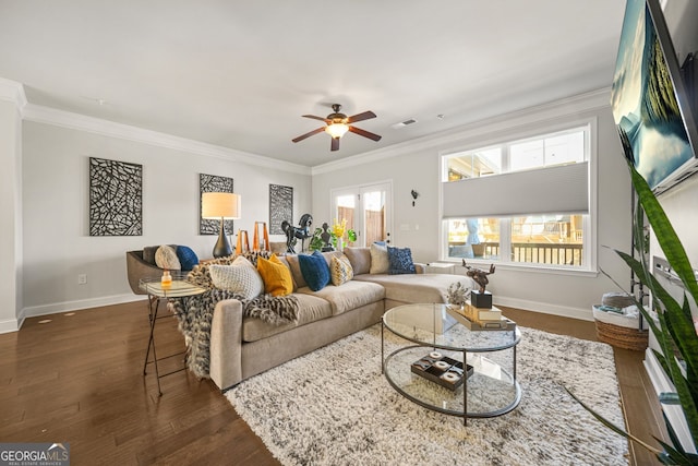 living room featuring baseboards, ornamental molding, and dark wood-type flooring