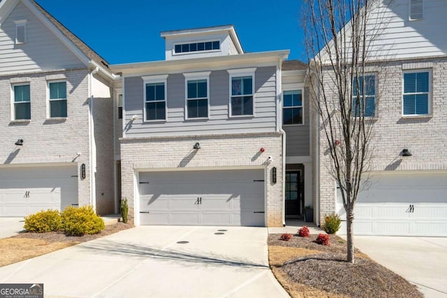 view of front of property featuring a garage, brick siding, and driveway